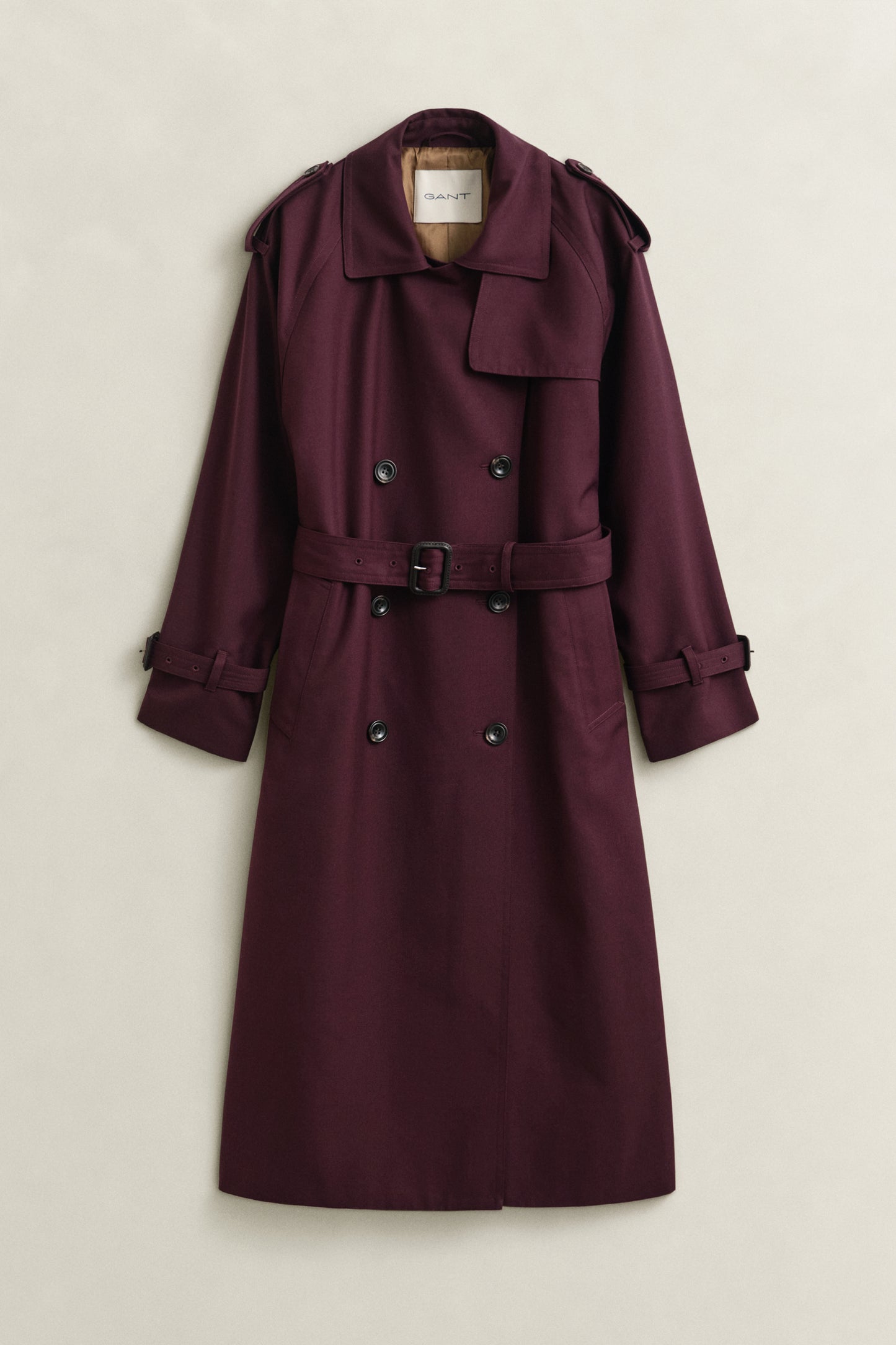 Purple trench coat on a light beige background
