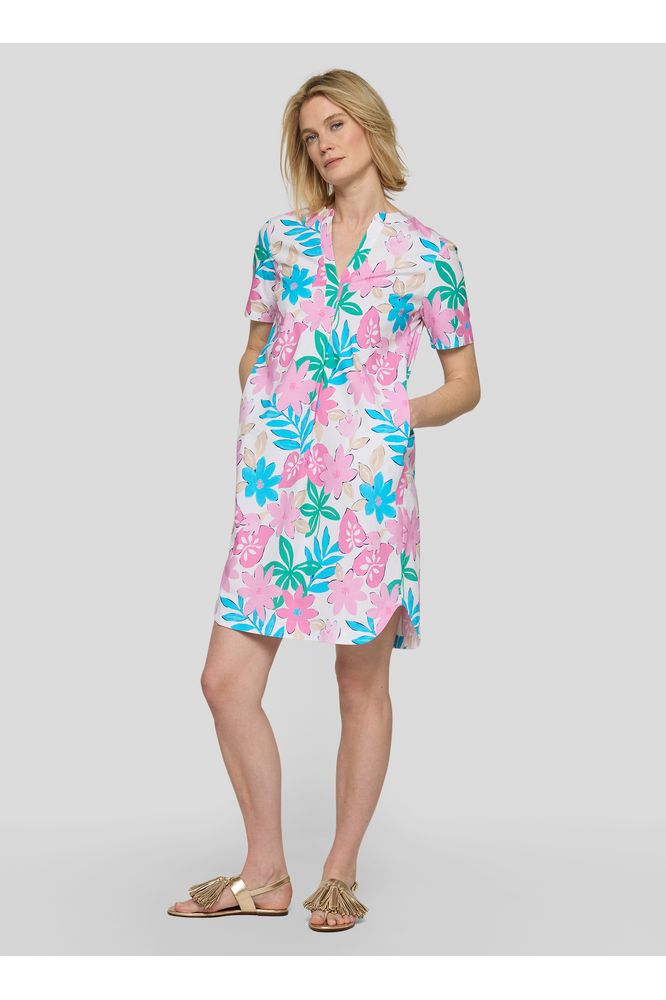 Woman wearing a colorful floral dress on a white background