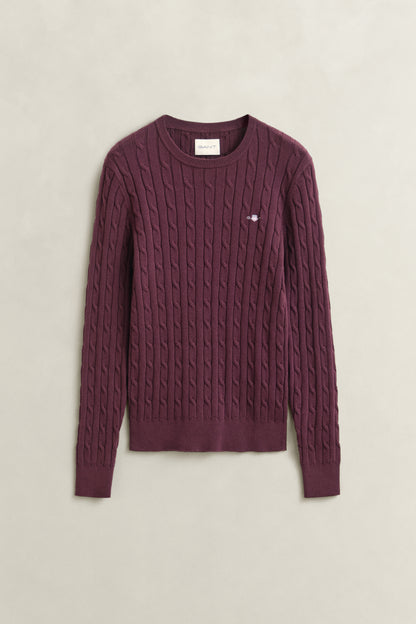 Maroon cable knit sweater on a light beige background